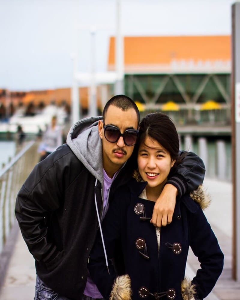 Couple smiling together on a waterfront walk